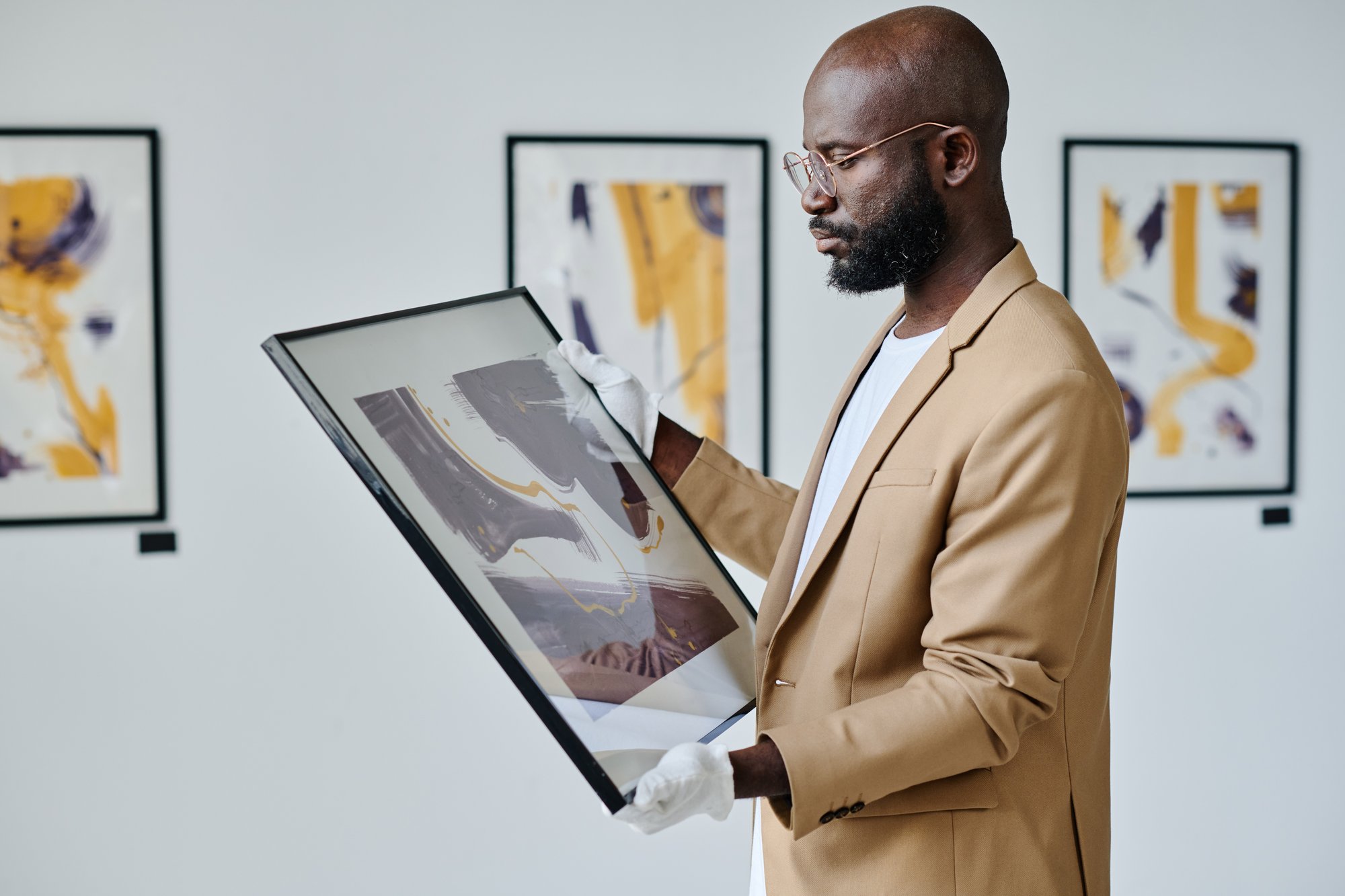 Art gallery with someone holding framed art