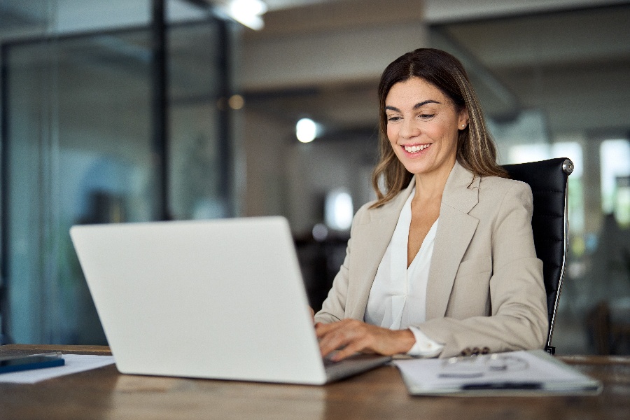 Professional working on laptop at a desk Professional working on laptop at a desk